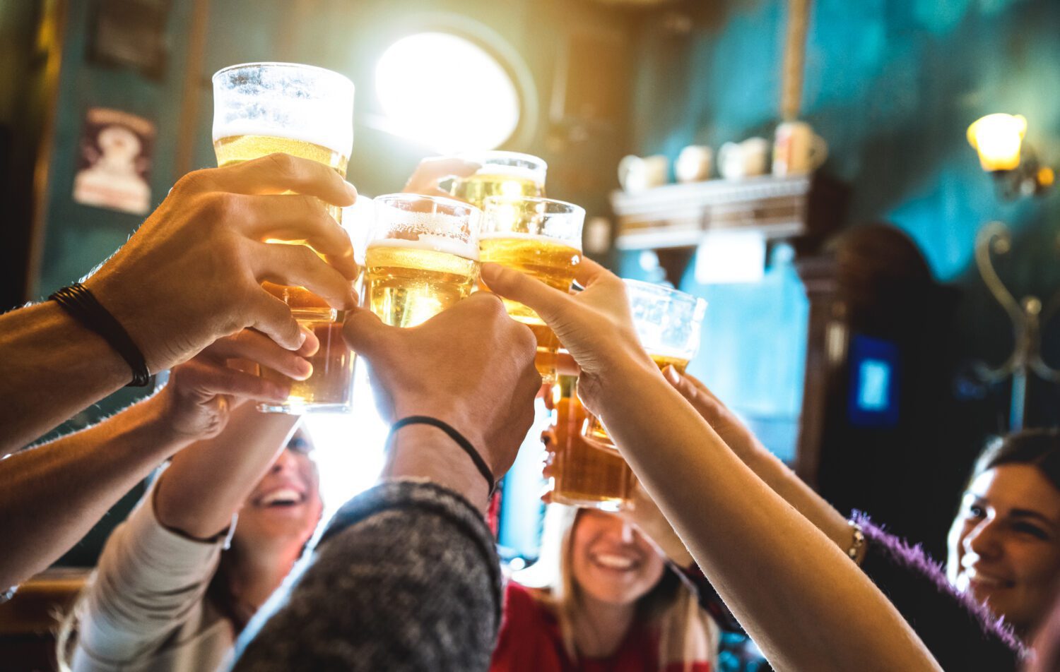 Group of friends raising a toast with beers