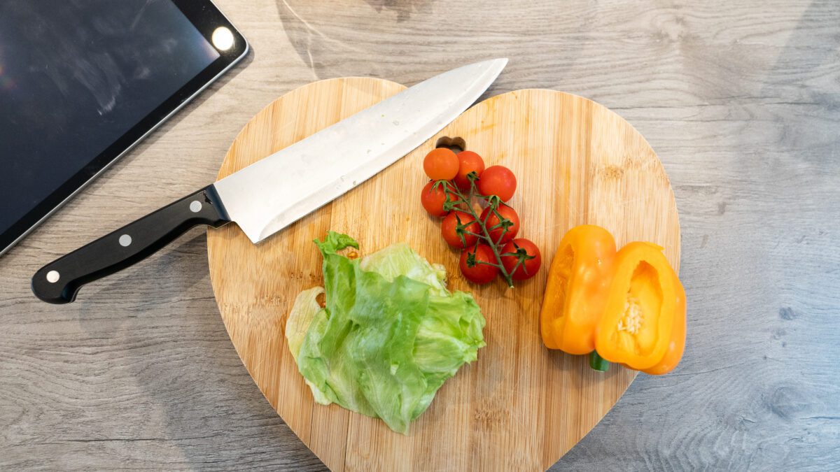 Love heart shape chopping board with pepper, tomatoes, and lettuce