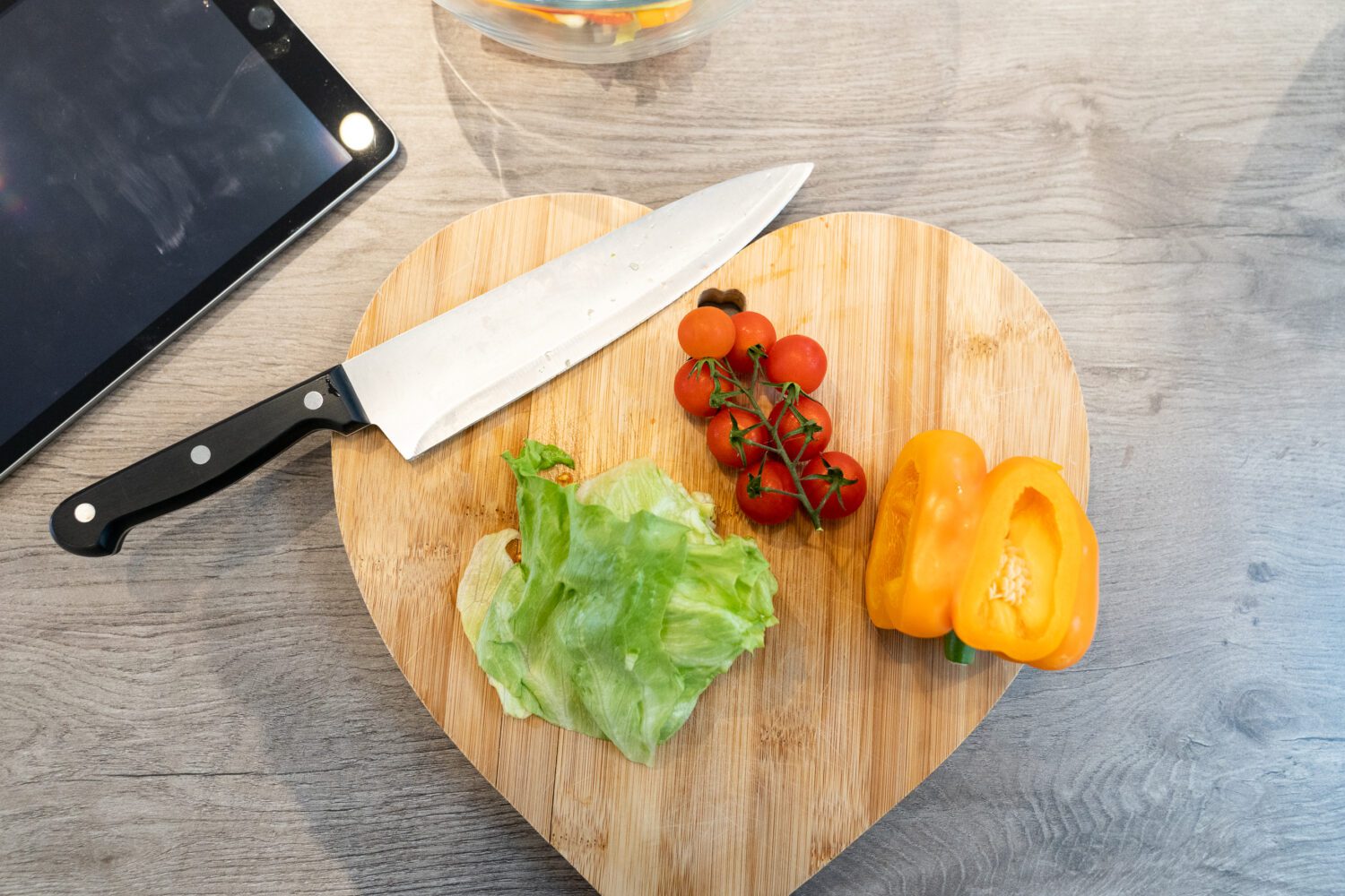 Love heart shape chopping board with pepper, tomatoes, and lettuce