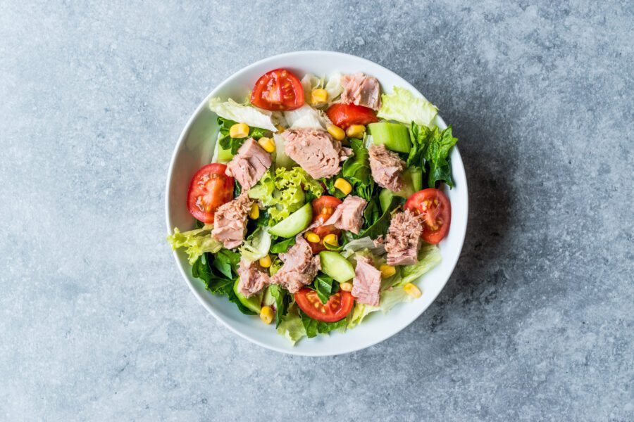 tuna salad with tomatoes, lettuce , and sweetcorn