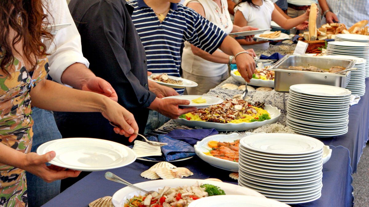 People serving themselves at a buffet