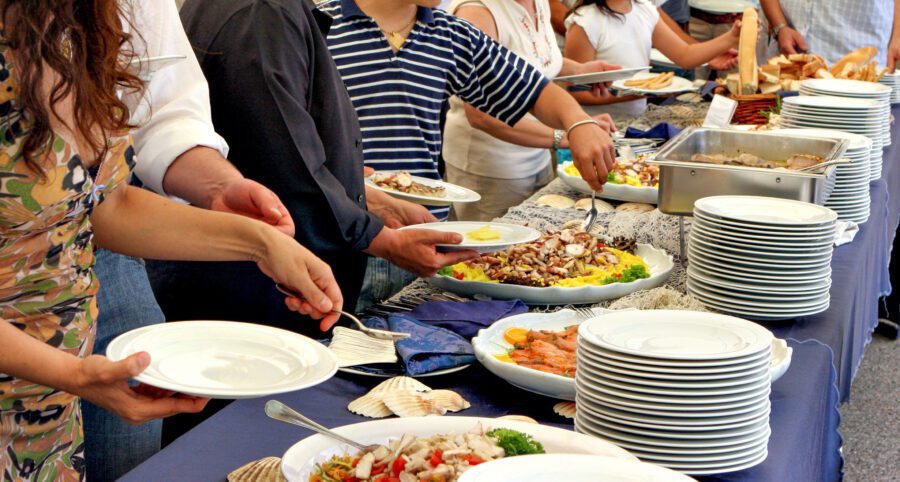 People serving themselves at a buffet