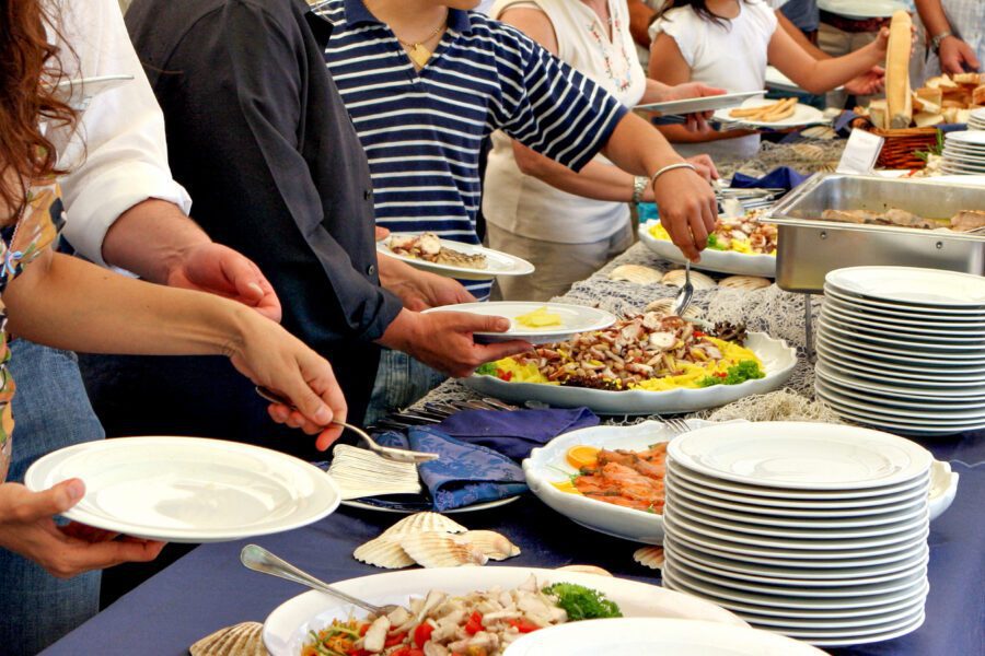 People serving themselves at a buffet