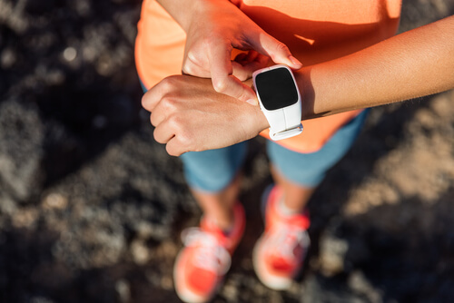 A woman's wrist with a smart watch on monitoring her after she has just gone for a run