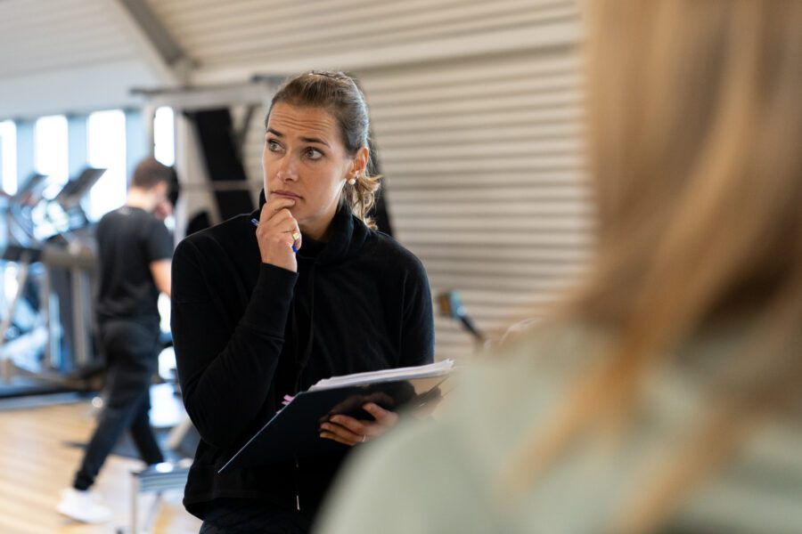 Personal training course tutor teaching a practical training class