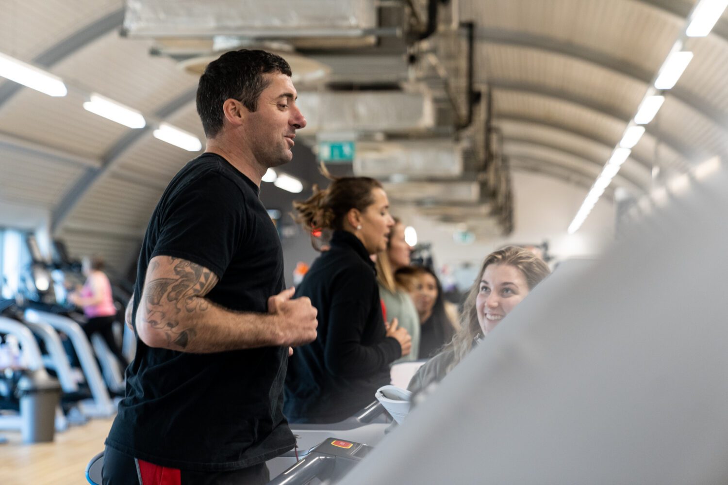 personal trainer exercising on treadmill