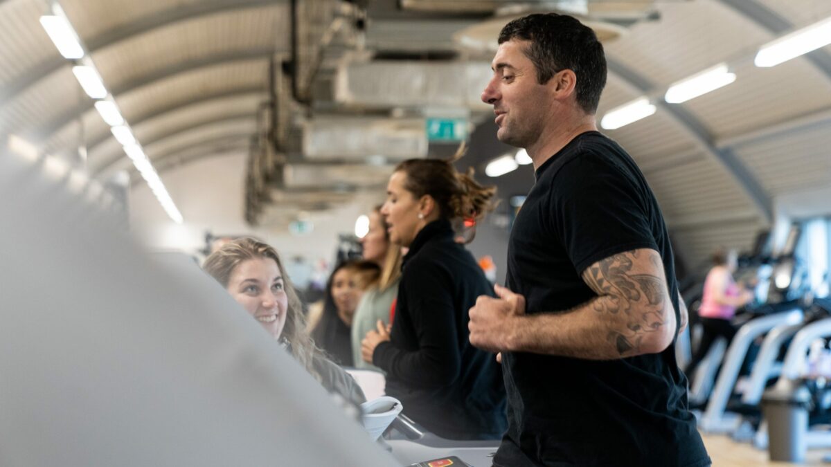 personal trainer exercising on treadmill