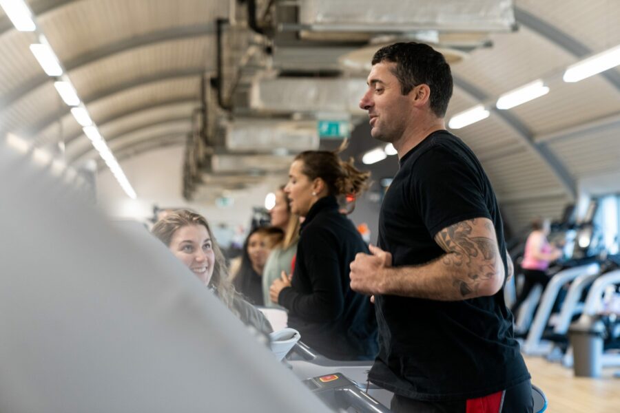 personal trainer exercising on treadmill