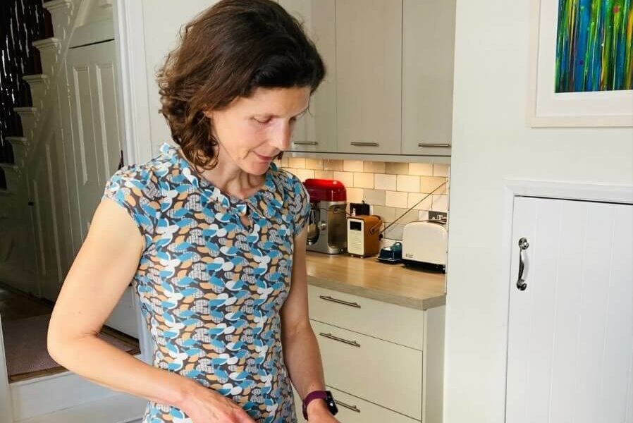 Jo Sardella chopping vegetables standing in her kitchen