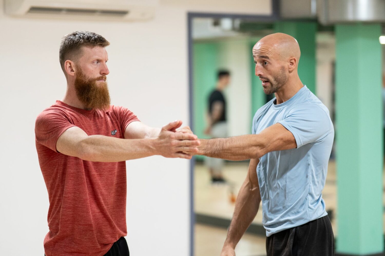 Personal trainer advising on client stretches