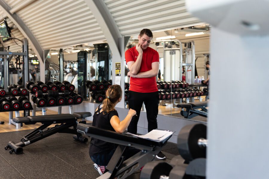 Personal trainer and client in a gym location