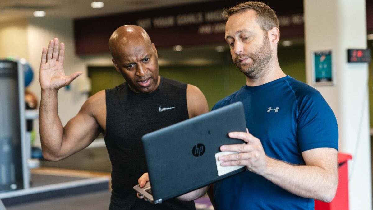 Personal trainer demonstrating functional movements to client