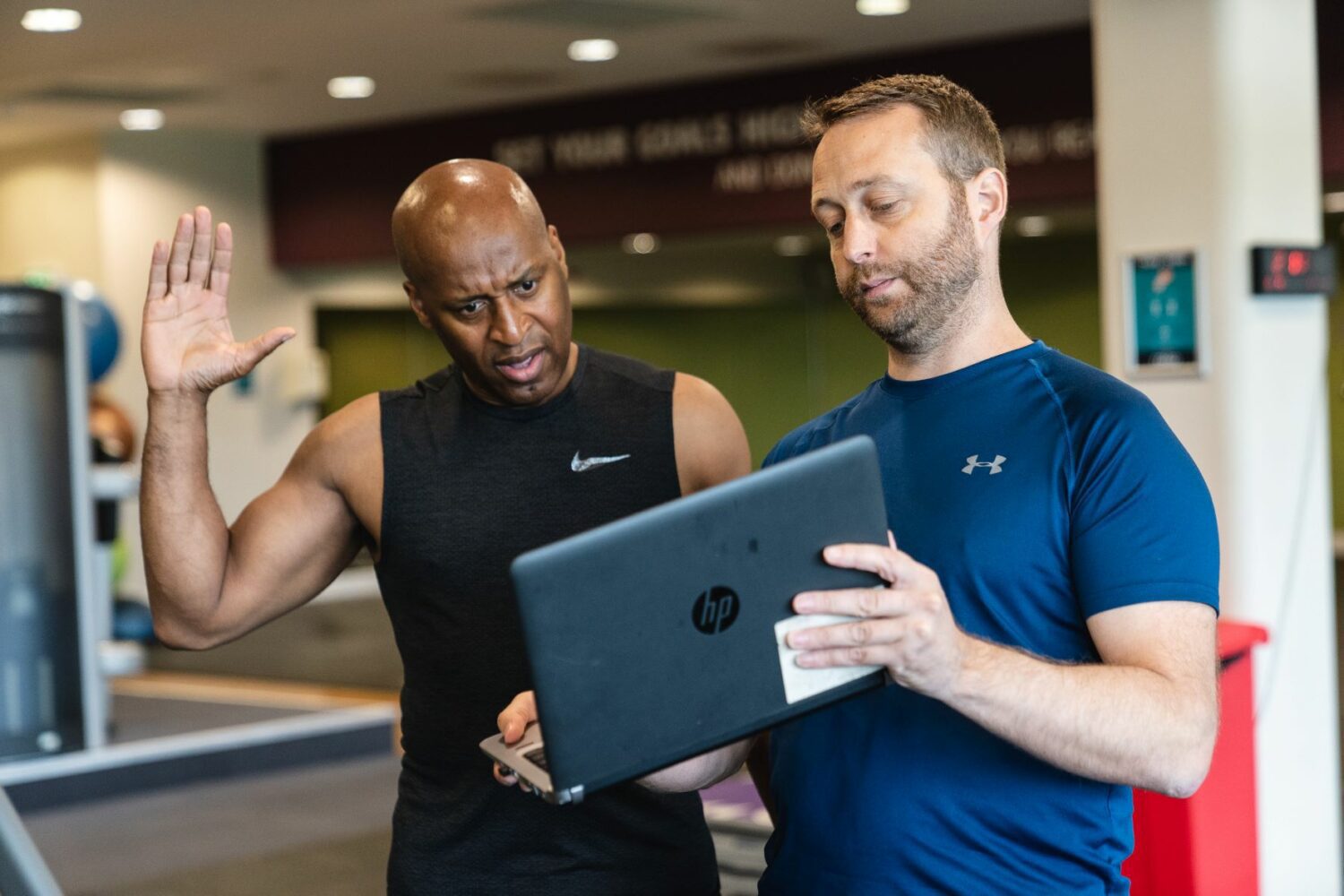 Personal trainer demonstrating functional movements to client