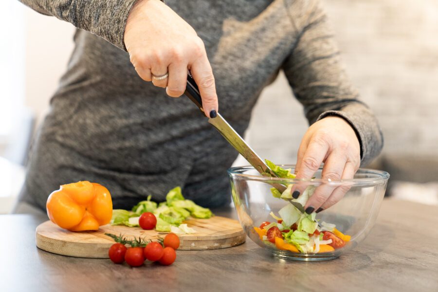 Nutrition coach making a salad