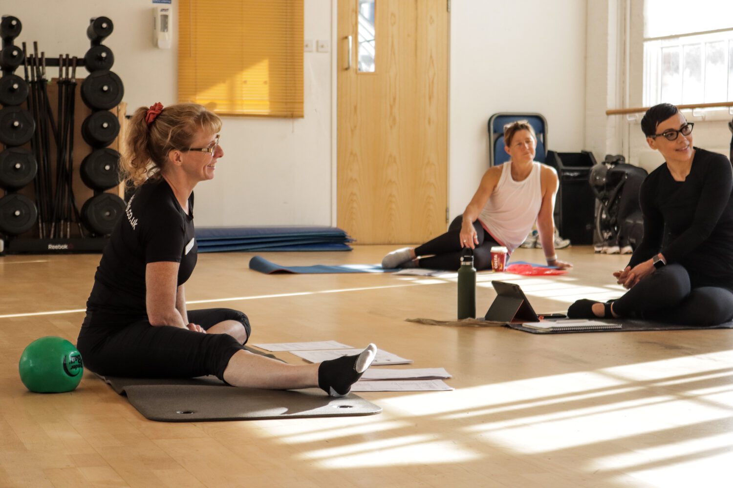 Pilates instructor teaching a class