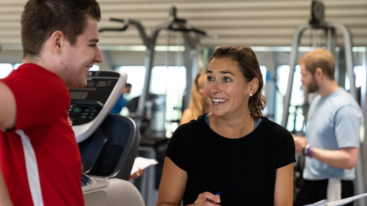 Personal trainer laughing with personal training client