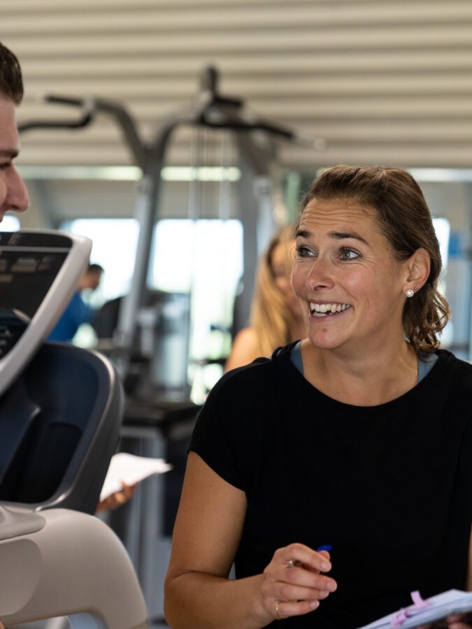 Personal trainer laughing with personal training client