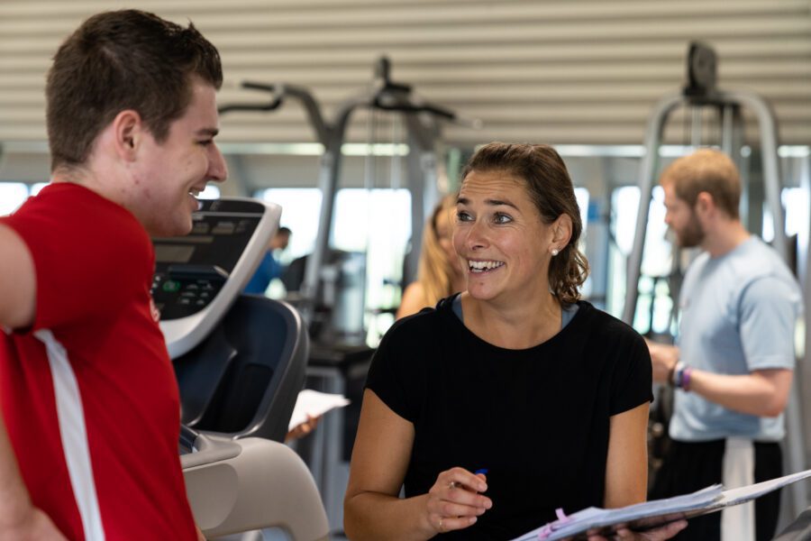 Personal trainer laughing with personal training client