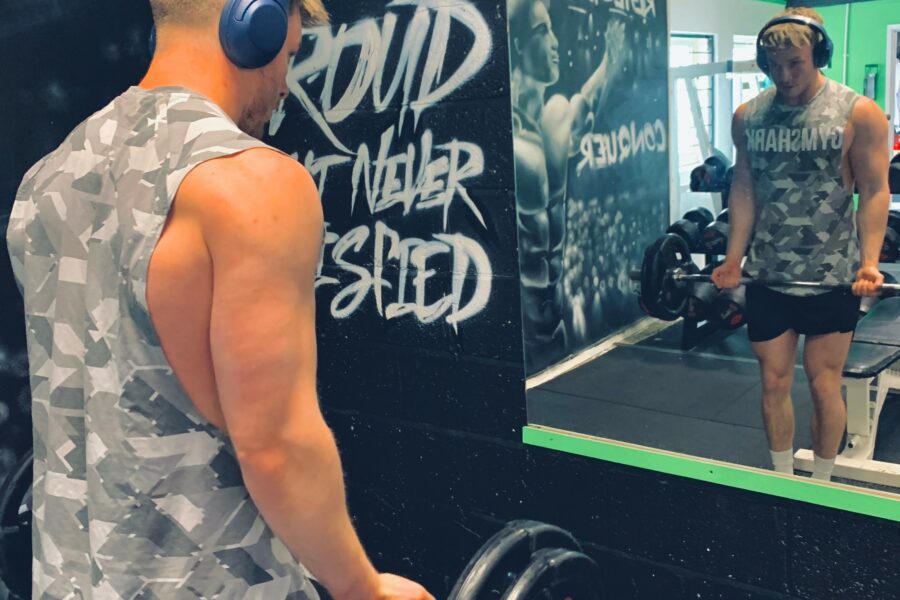 Jack looking into a mirror, lifting weights