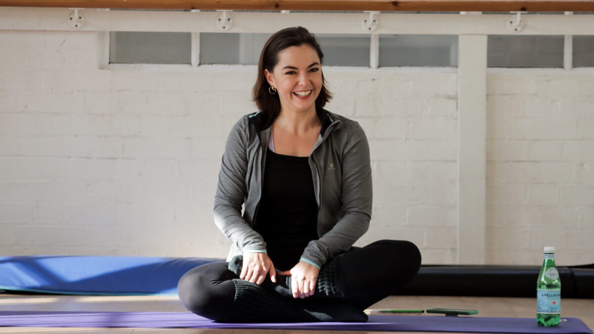 Pilates mat instructor running a class