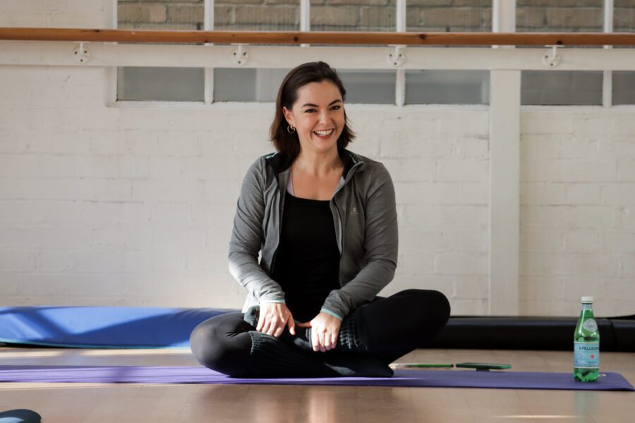 Pilates mat instructor running a class