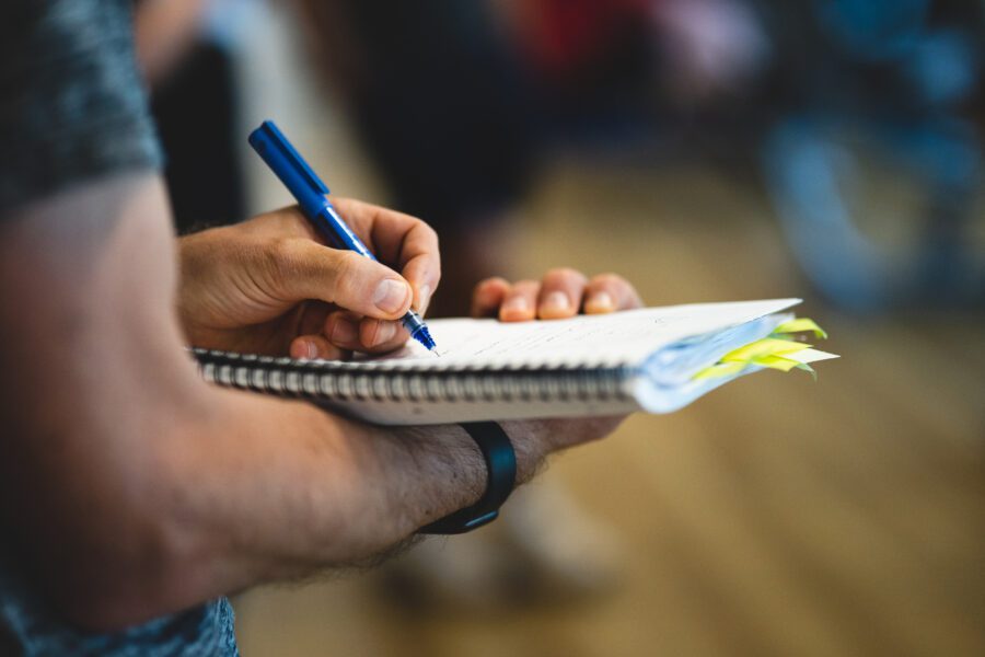 Student taking notes in a notebook