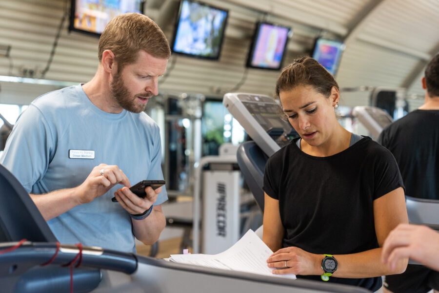 Personal training course tutor talking student through an exercise