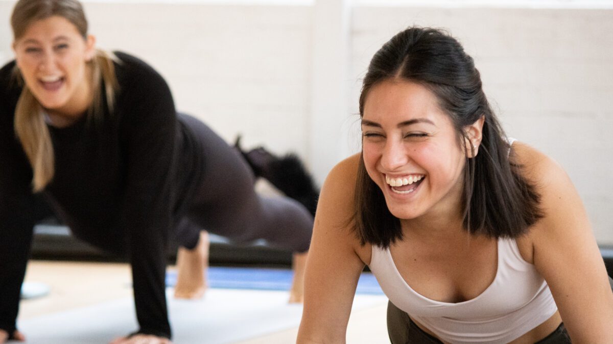 Pilates instructor course student laughing in practical training
