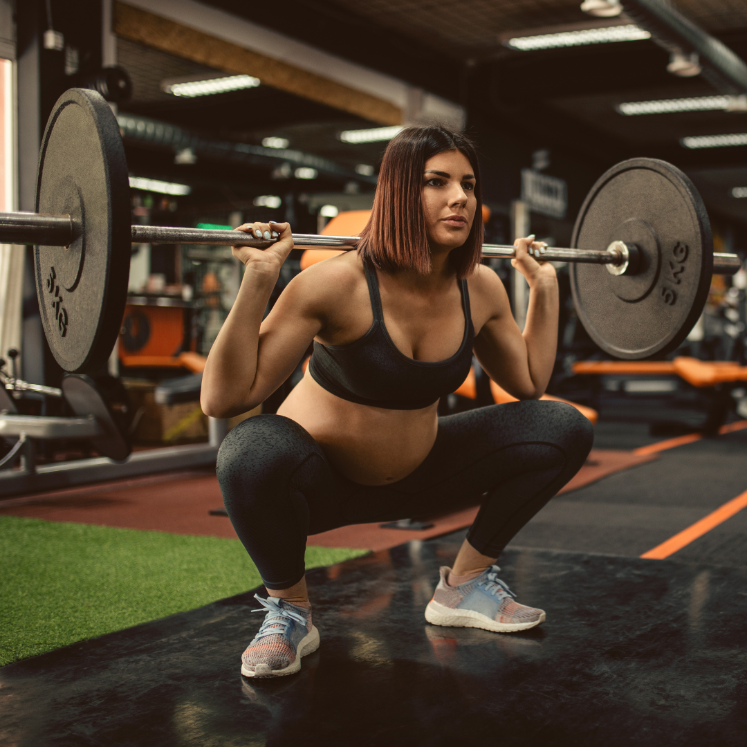 Pregnant woman doing a weighted barbell back squat.