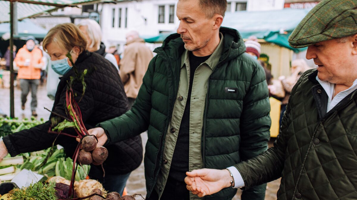 James Ellis and Jason Shaw of Elevated Food for Life browsing at a Farmers' Market