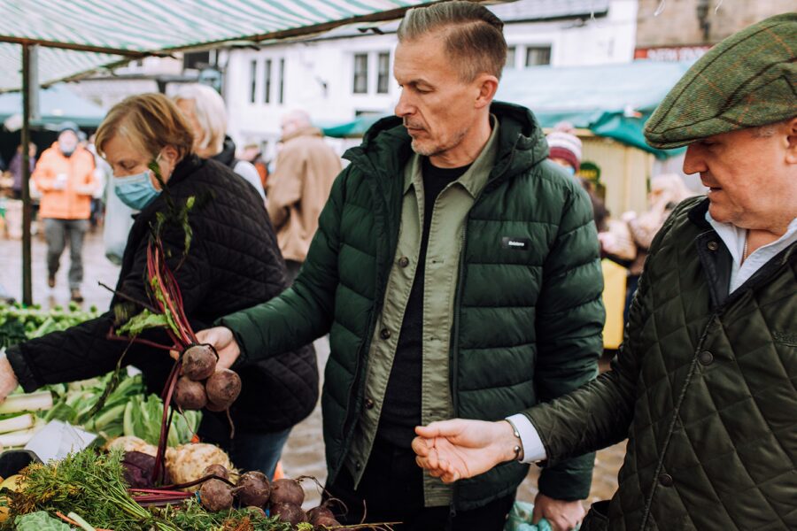 James Ellis and Jason Shaw of Elevated Food for Life browsing at a Farmers' Market