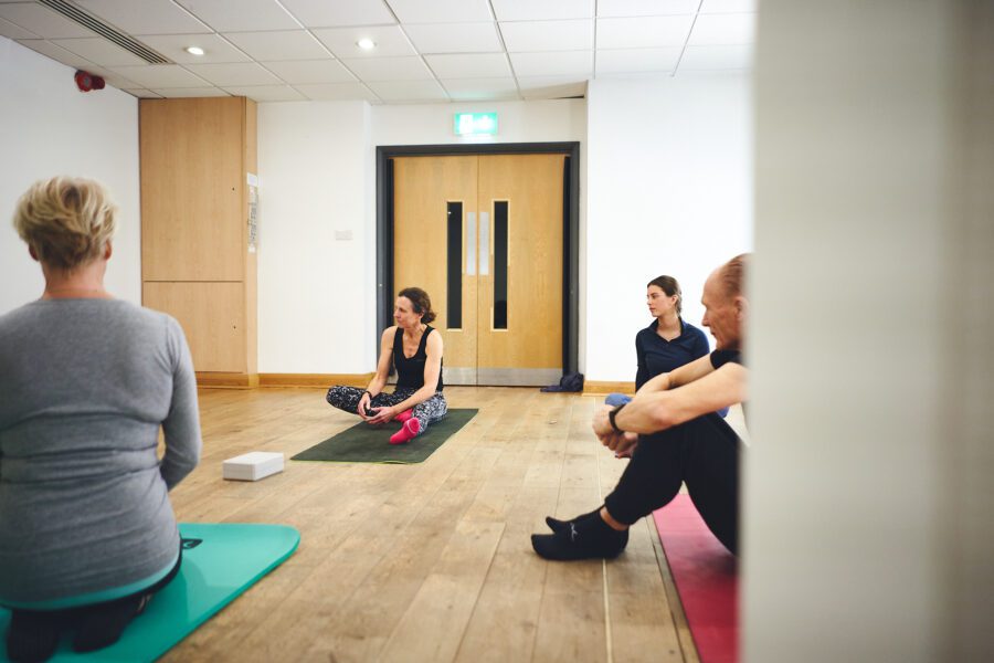 group of people sat in a pilates class