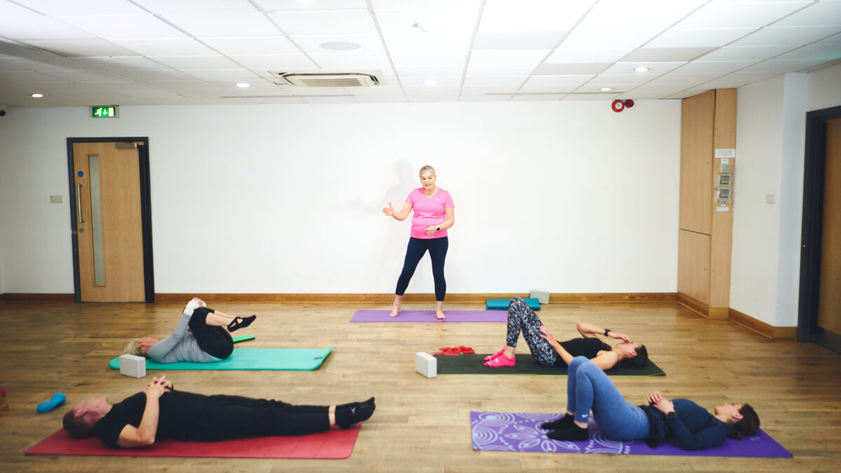 instructor teaching class pilates techniques