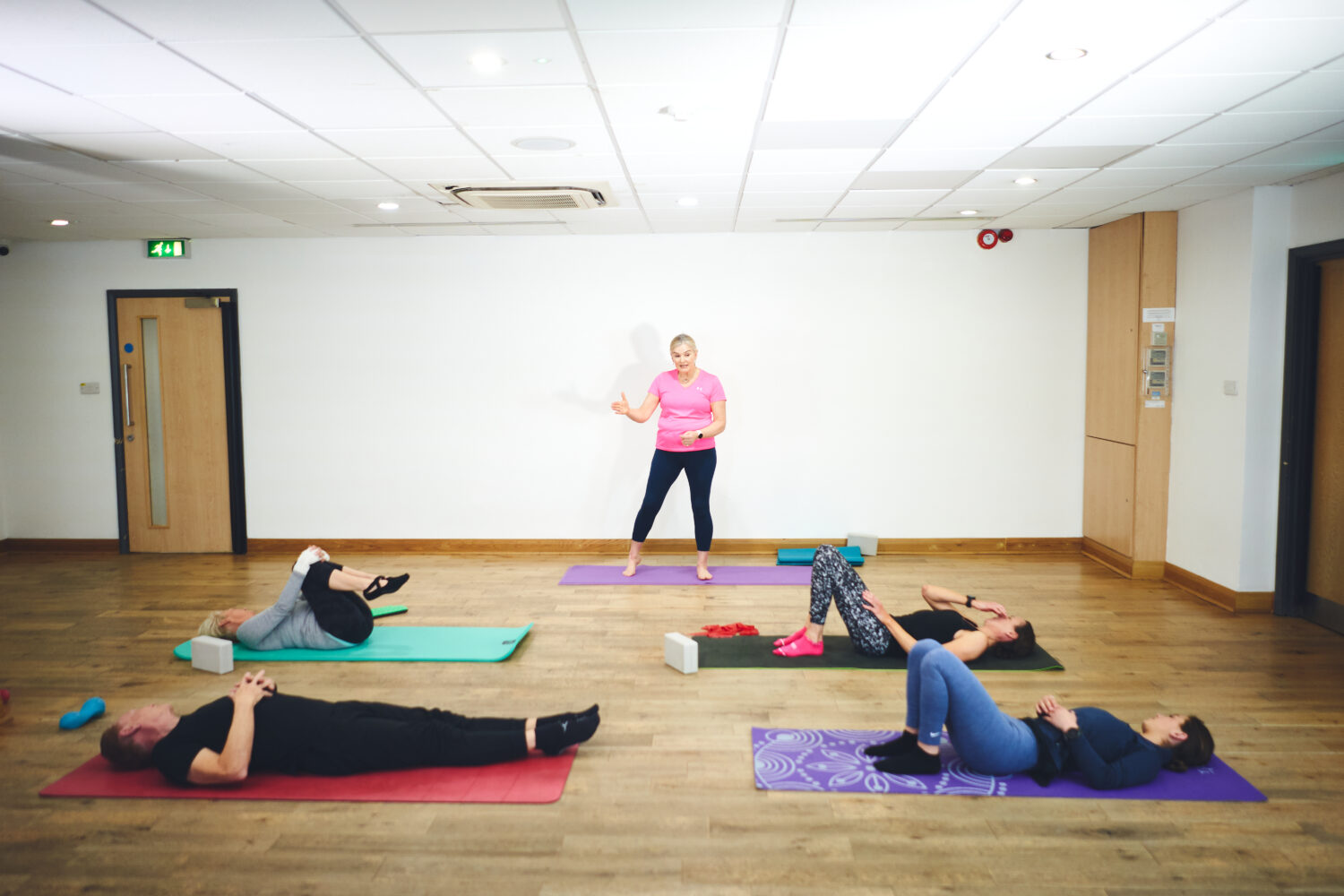 instructor teaching class pilates techniques