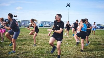 Fitness instructor leading an exercise to music class