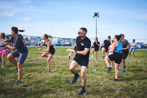 Fitness instructor leading an exercise to music class